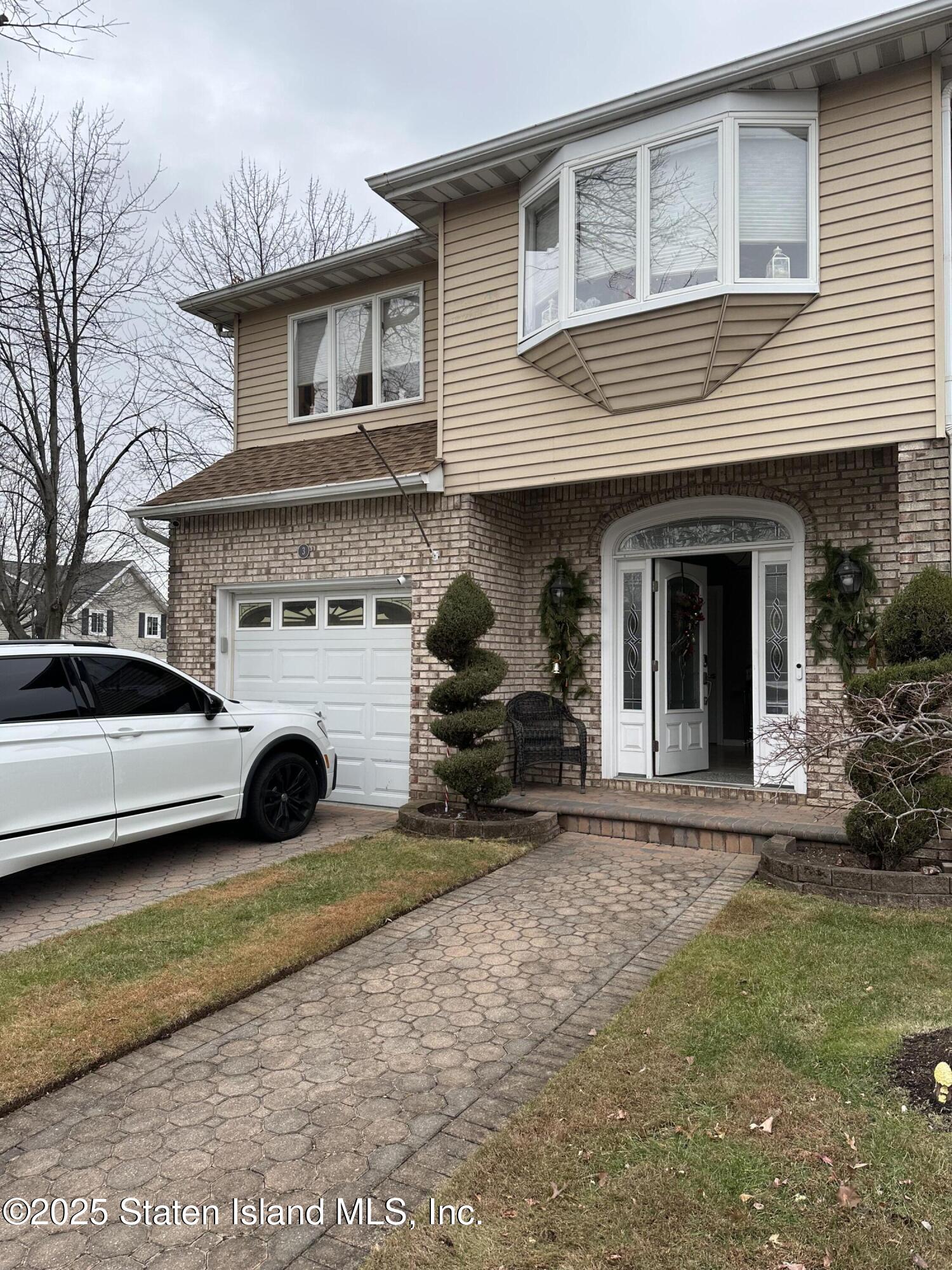 a view of a house with a yard and sitting area