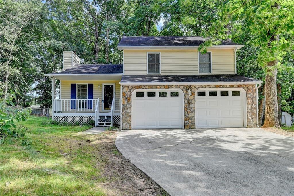 a house that has a tree in front of the house