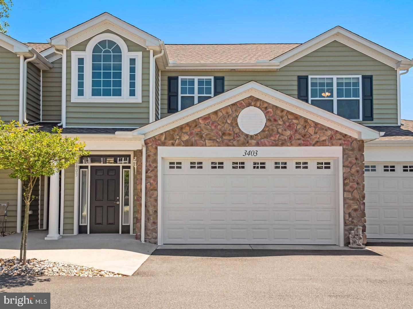 a front view of a house with a garage