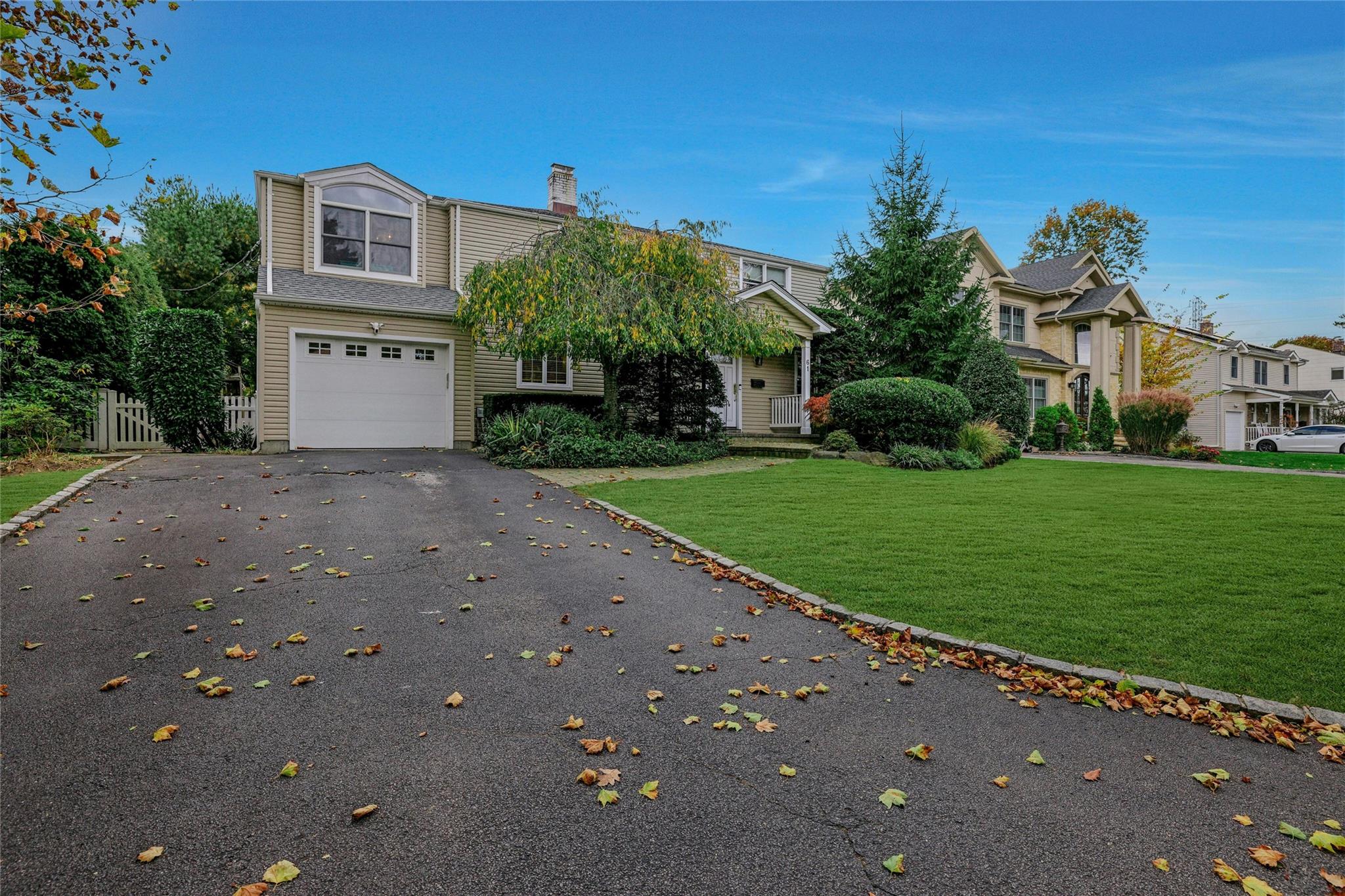 View of front of home with a garage and a front yard