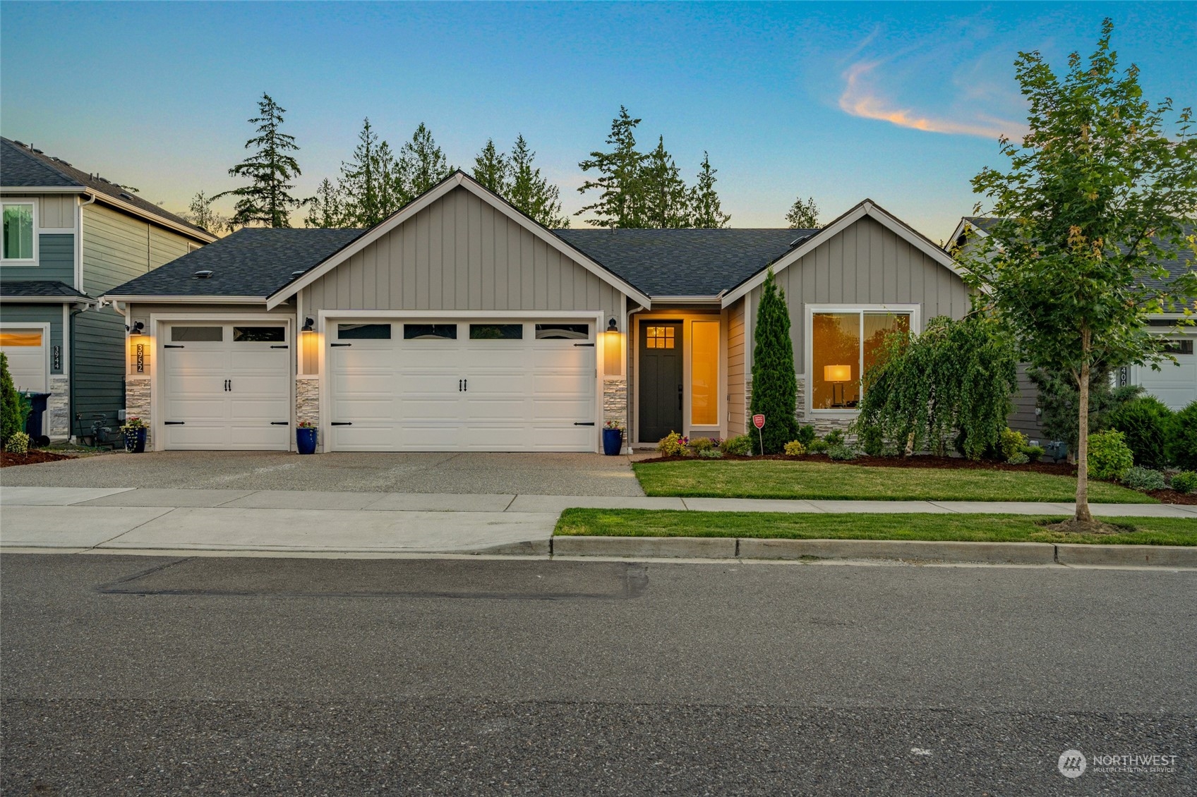 a view of a house next to a yard and garage