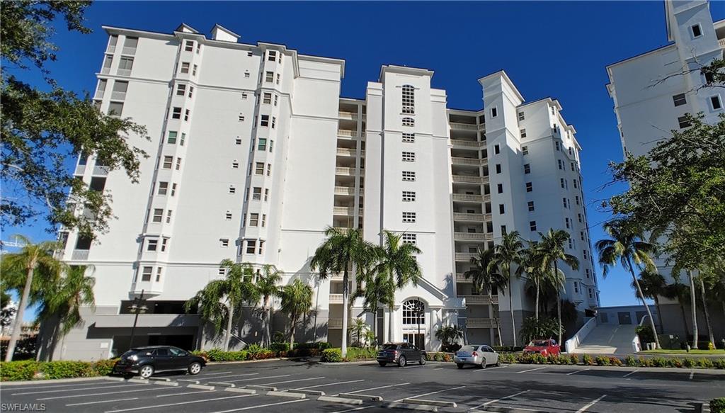 a view of a tall building next to a road