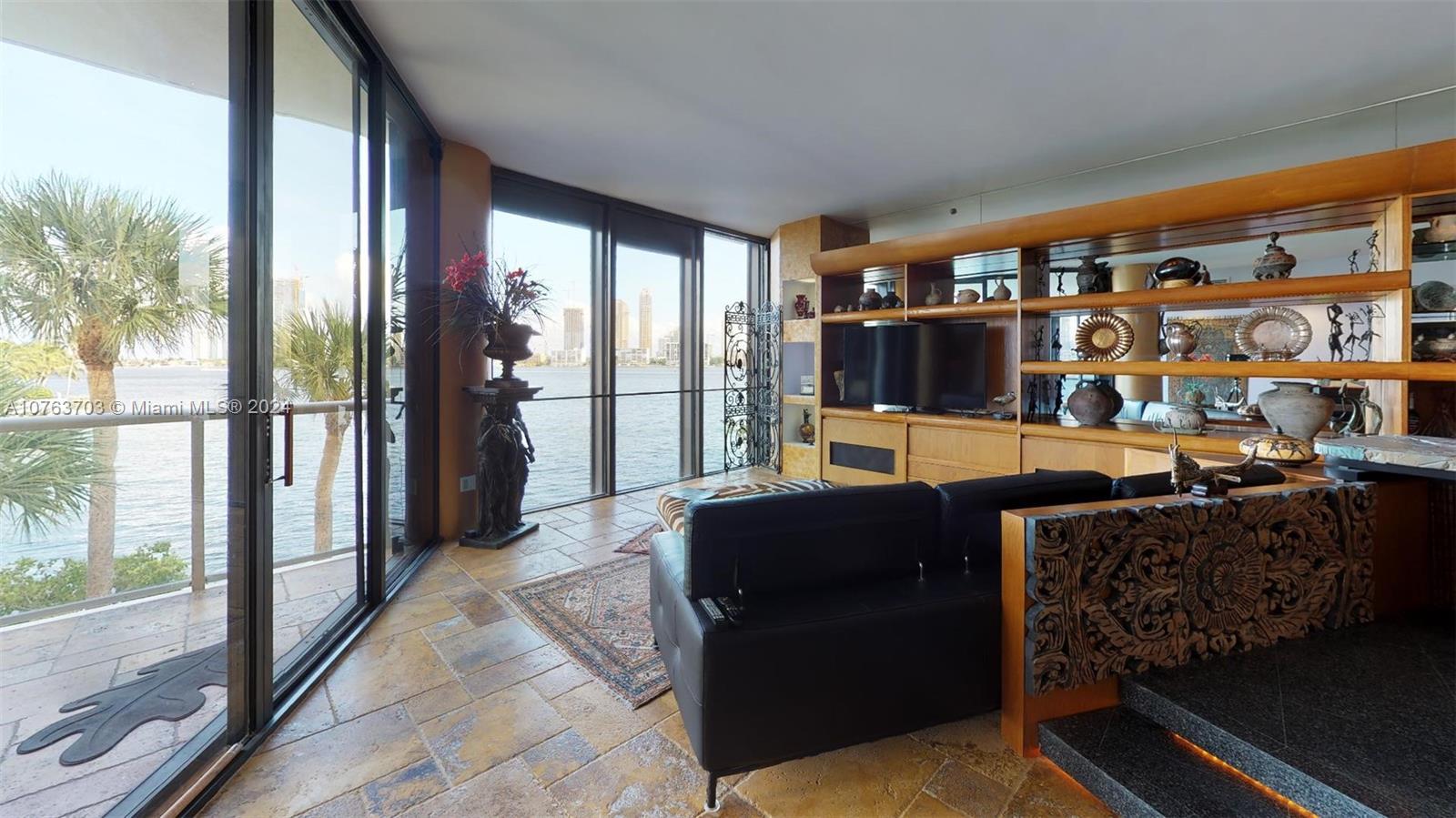 a living room with furniture and a floor to ceiling window