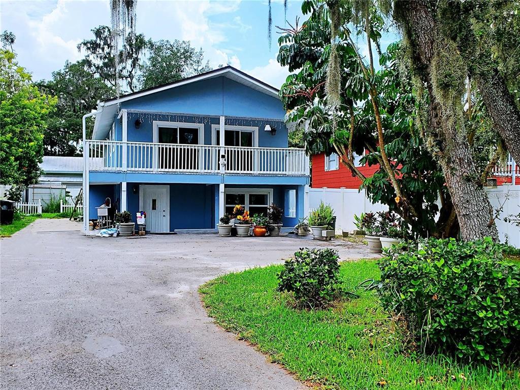 a front view of a house with yard and green space