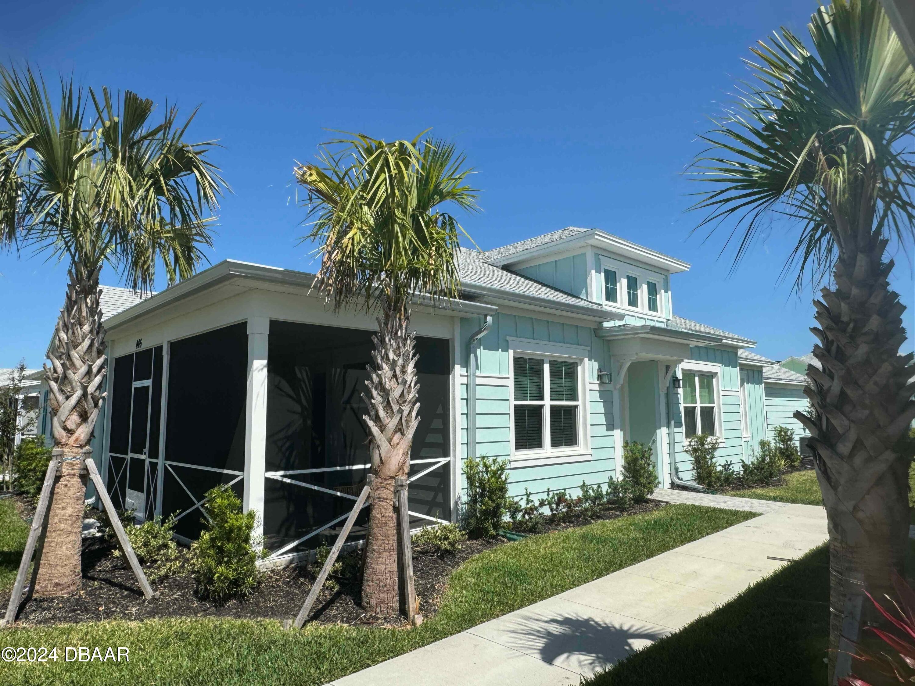 a front view of a house with plants