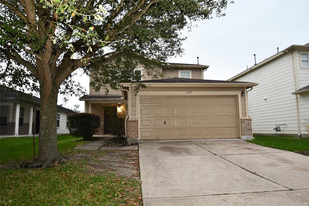 a view of a house with a yard and garage