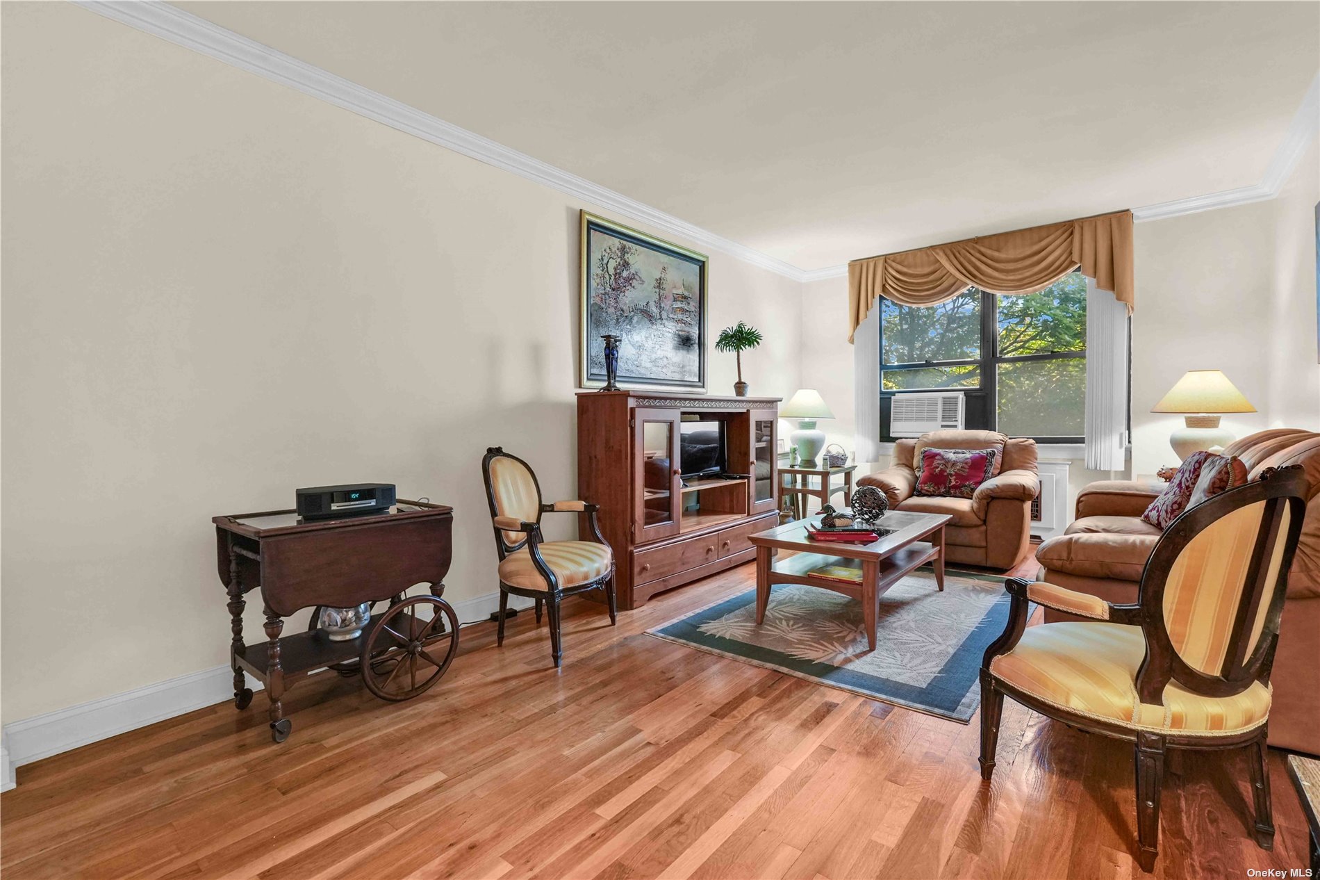 a living room with furniture a table and wooden floor