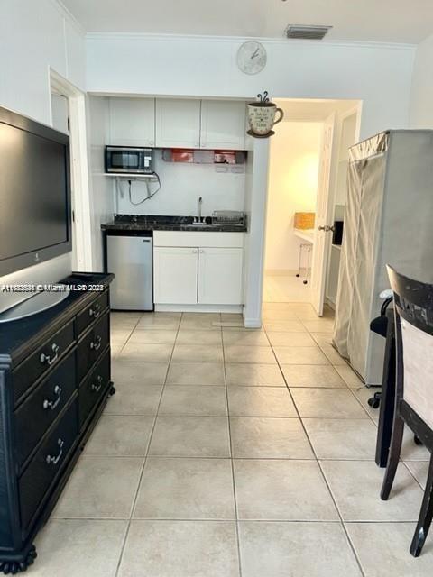 a kitchen with a stove a sink and a refrigerator