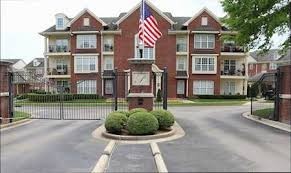 a front view of a residential apartment building with a yard