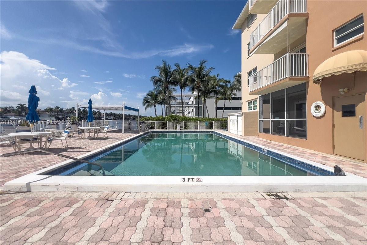 a view of a swimming pool with a yard