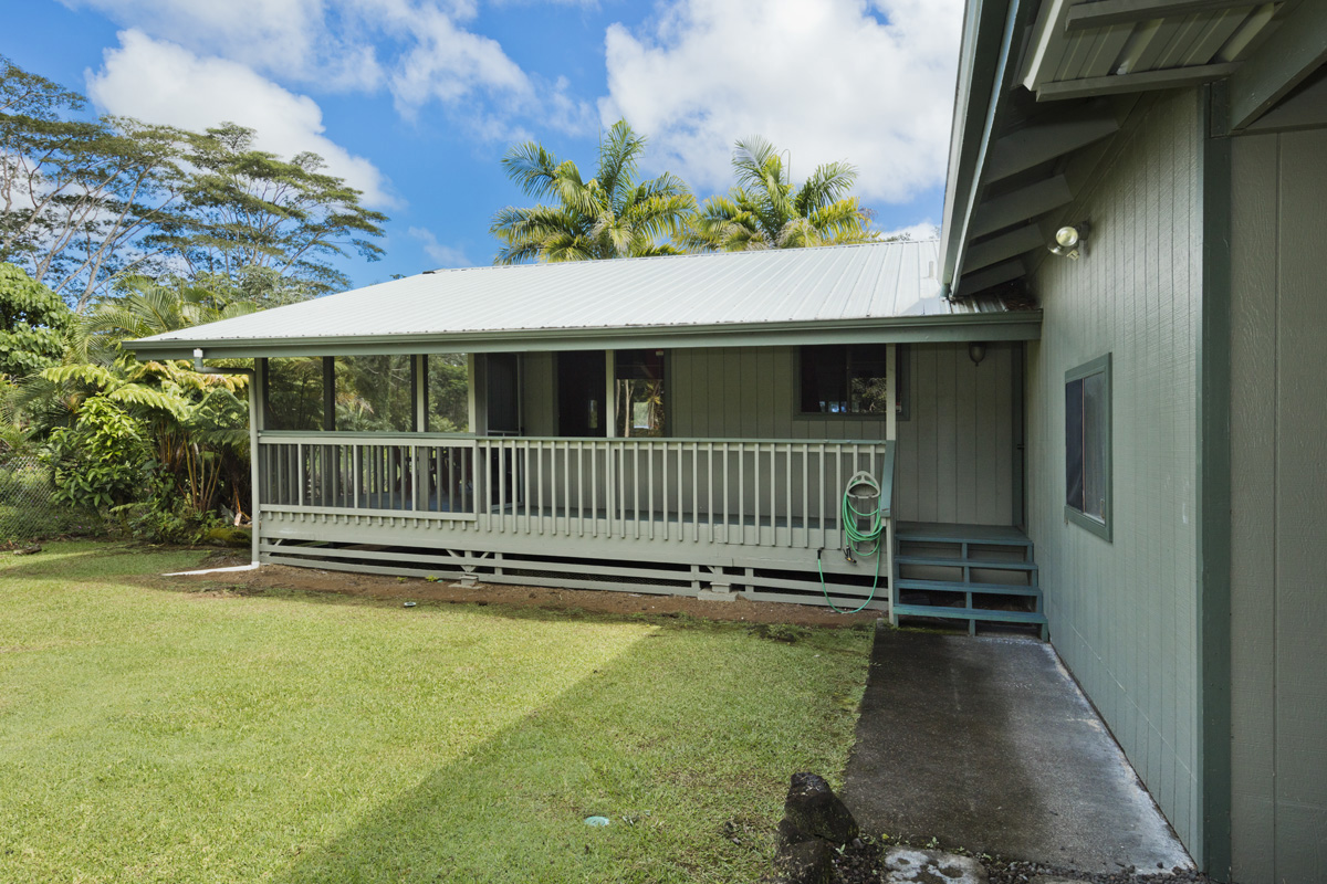 a view of a deck with a small yard