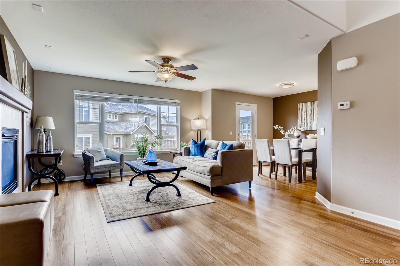 a living room with furniture dining table and a large window