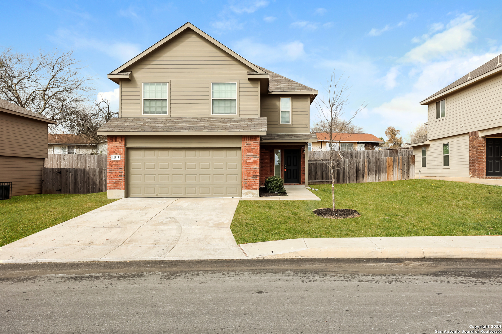 a front view of a house with a yard and garage