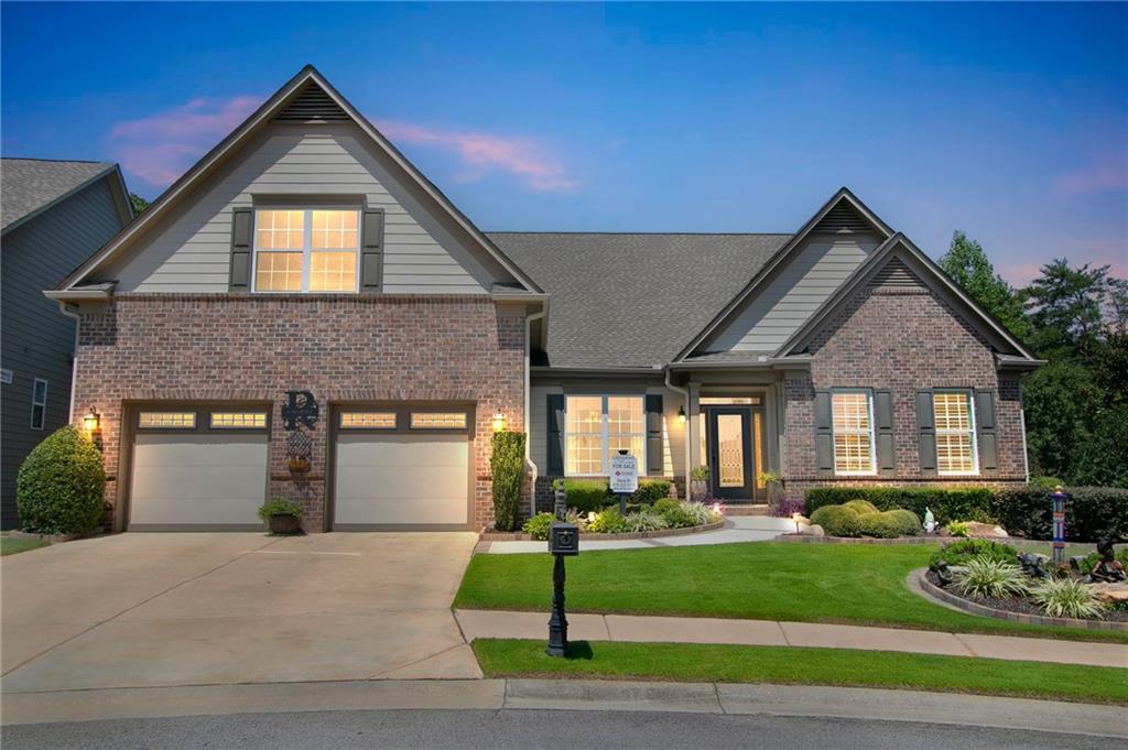 a front view of a house with a yard and garage