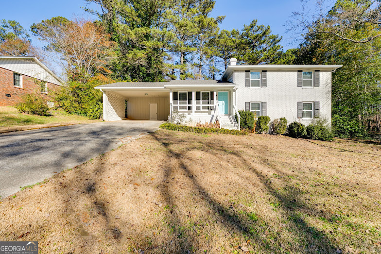 a front view of a house with a garden