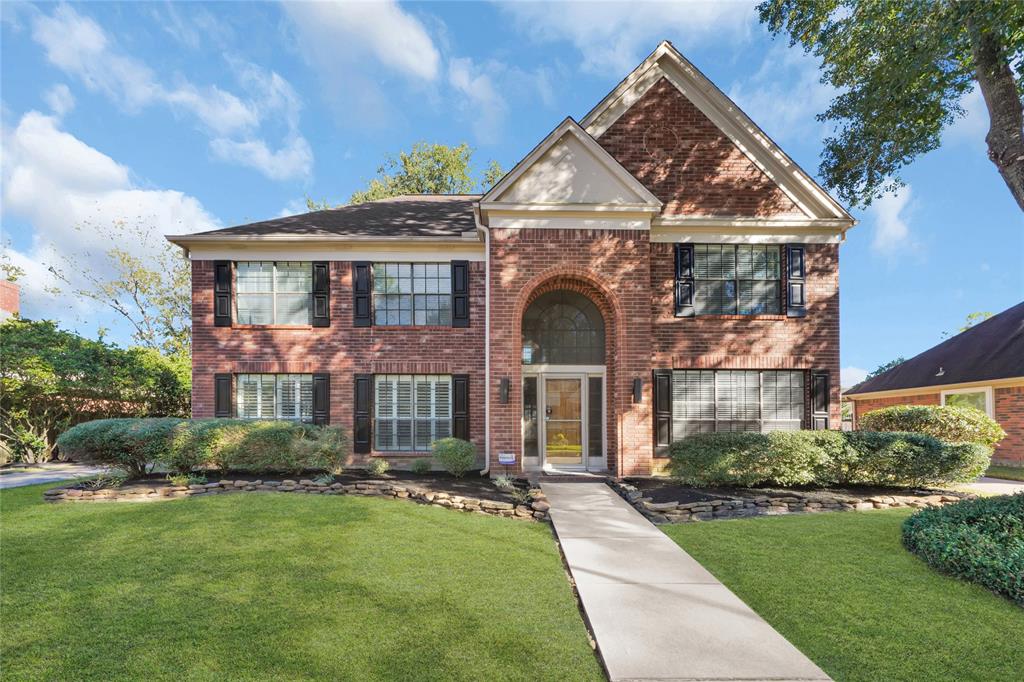 Welcome to this charming two-story brick home, boasting an inviting entryway and pristine landscaping.