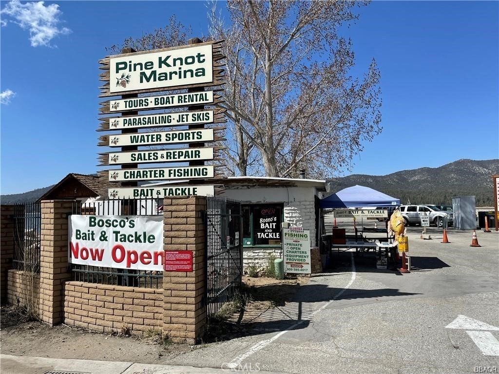 a view of a building with retail shops and traffic signal