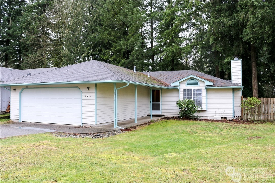 a front view of a house with yard and garage