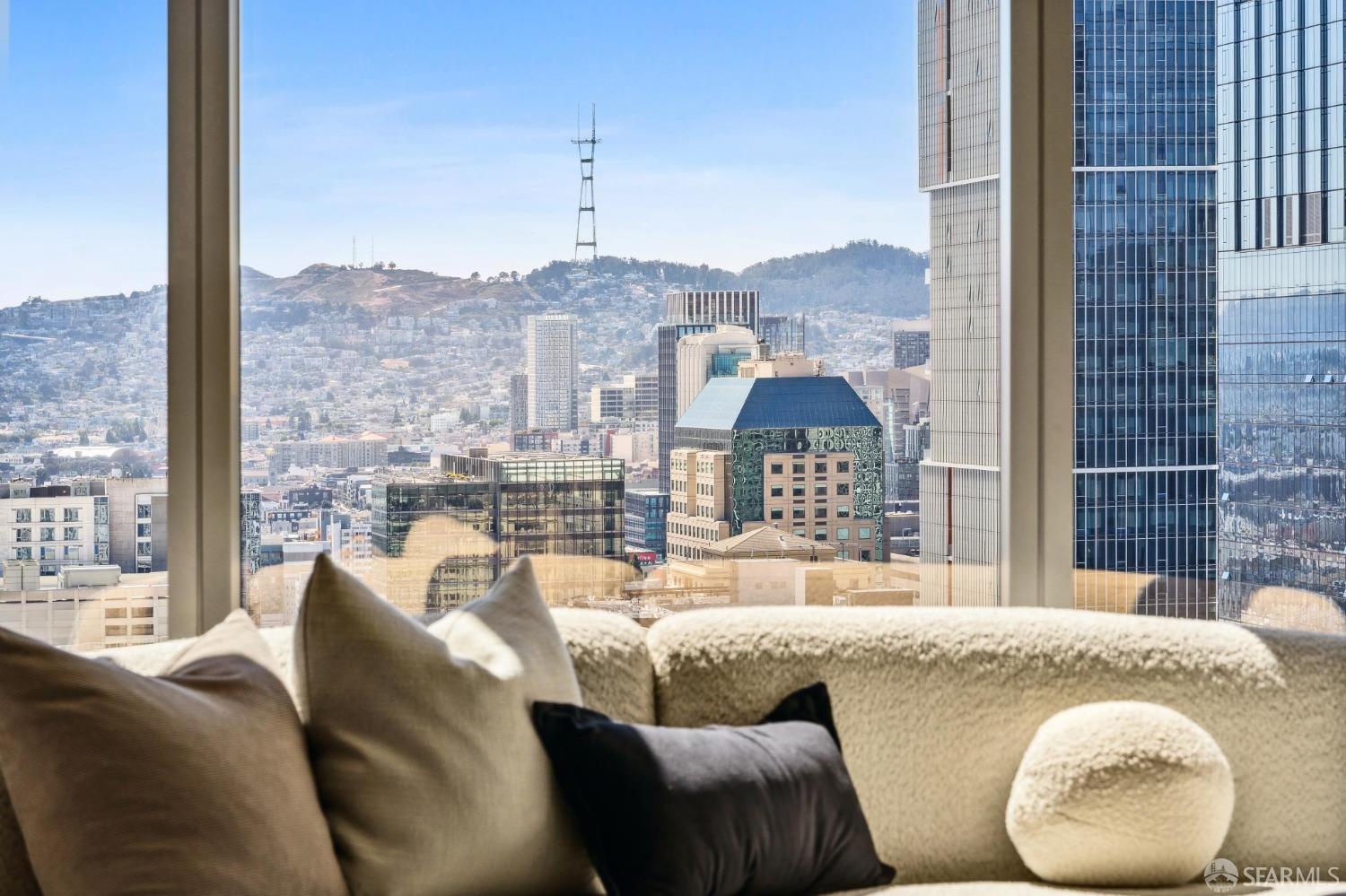 a living room with a couch and a floor to ceiling window