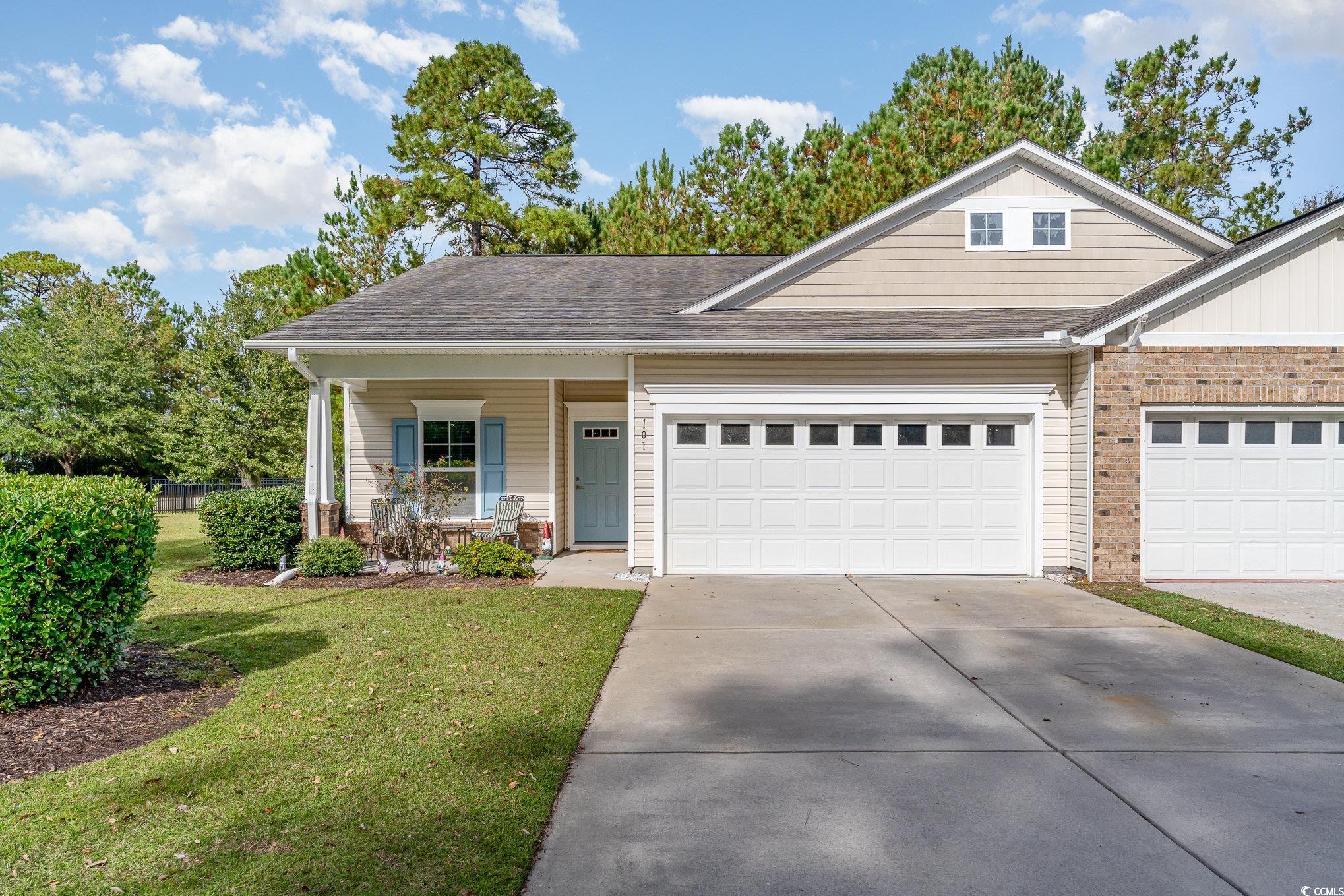 View of front of house with a porch, a front lawn,