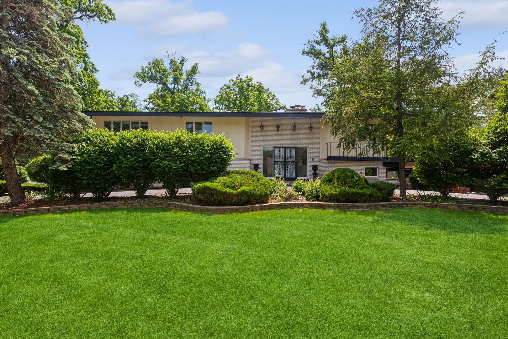 a view of a house with backyard sitting area and garden