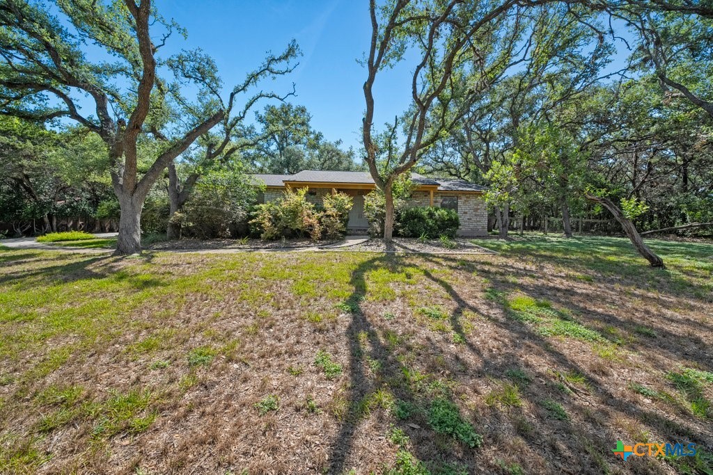 a view of a house with swimming pool and sitting area