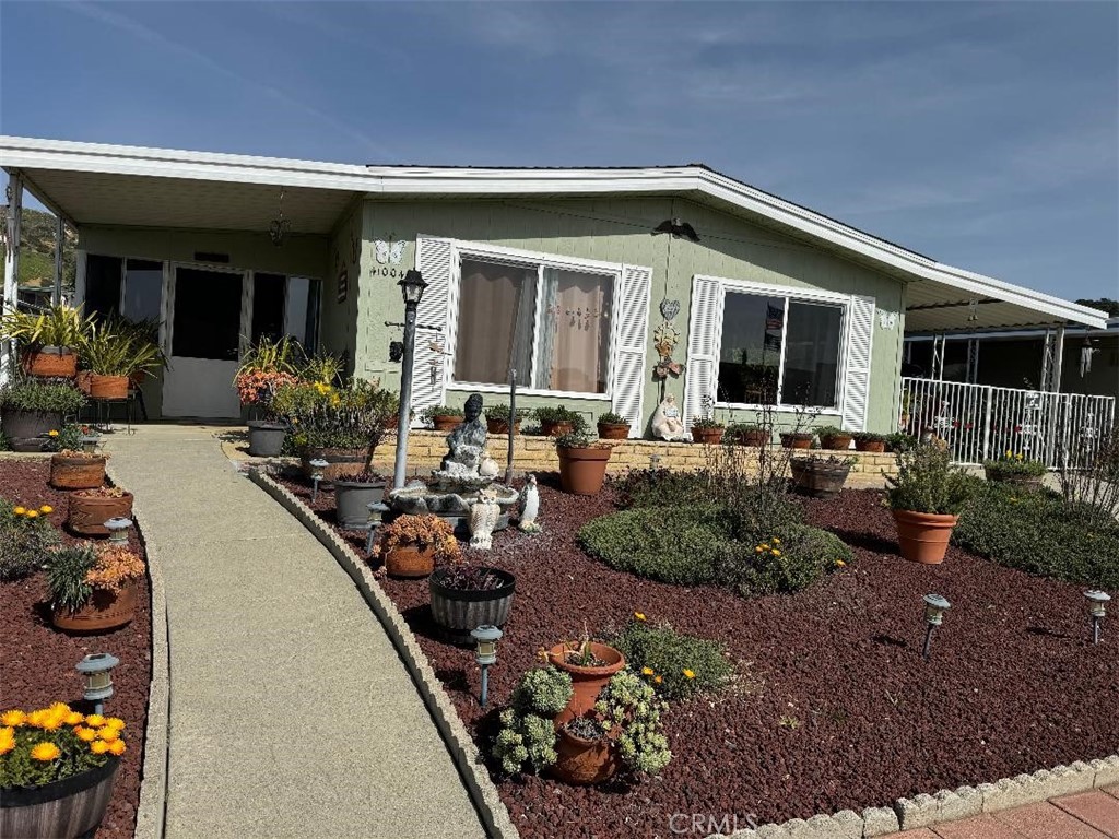 a front view of a house with outdoor seating