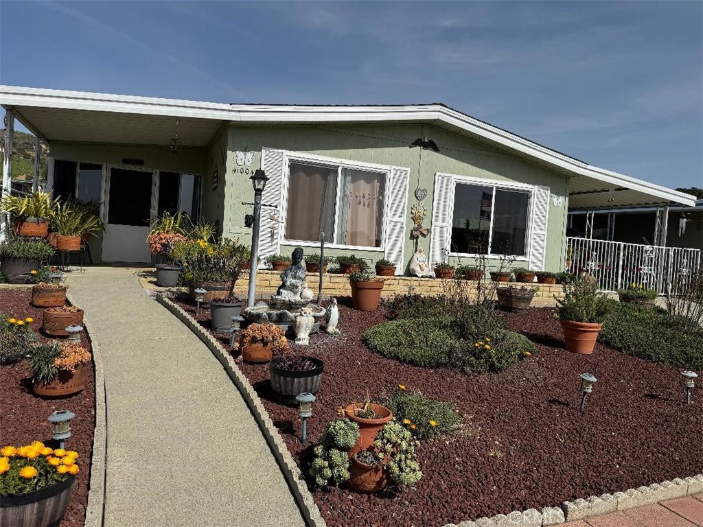 a front view of a house with outdoor seating