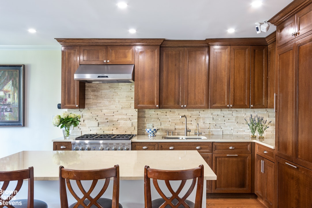 a kitchen with granite countertop wooden cabinets and white appliances