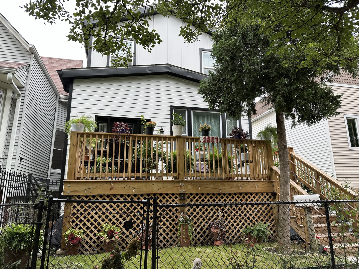 a front view of a house with a iron gate