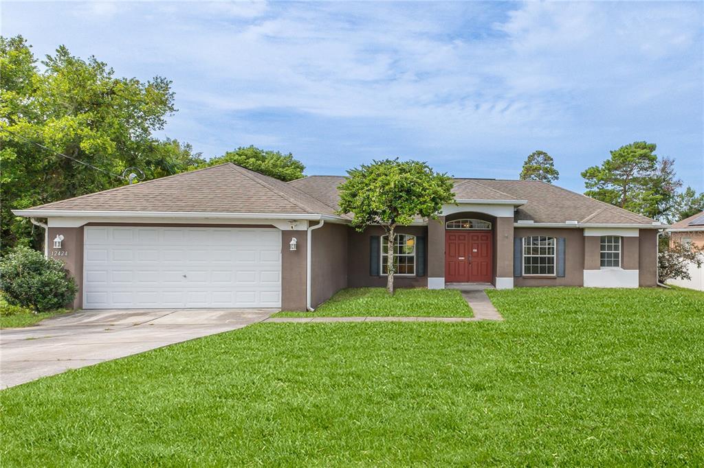 a front view of a house with a yard and garage