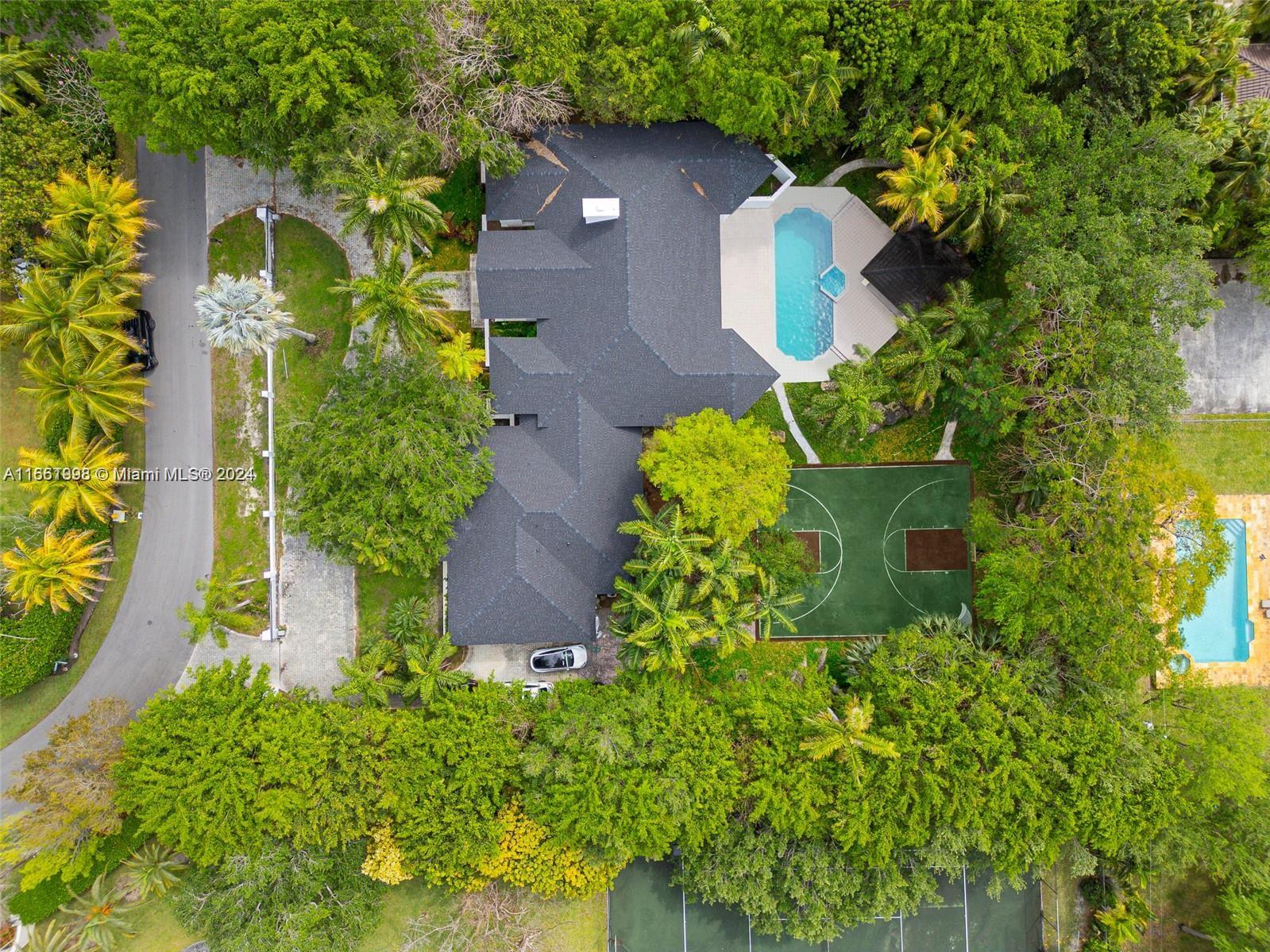 an aerial view of a house with a yard and garden