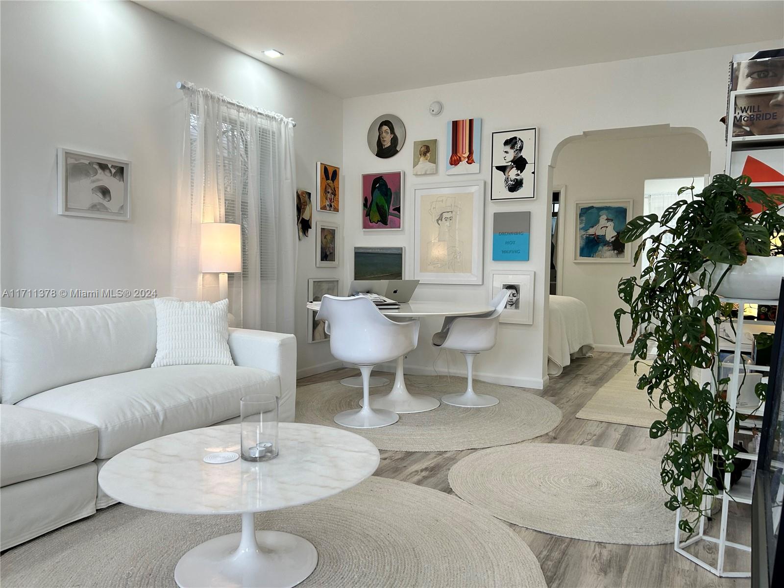 a living room with furniture potted plant and a chandelier