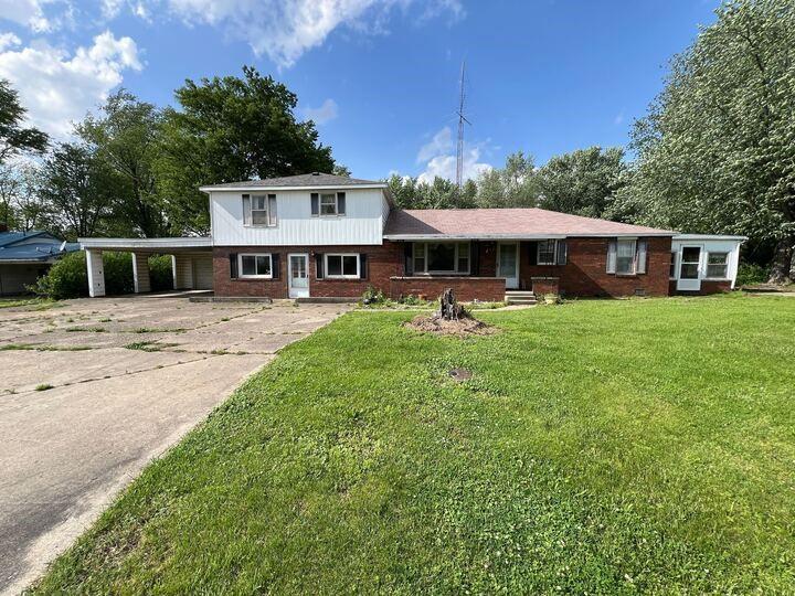 a view of a house with backyard porch and sitting area