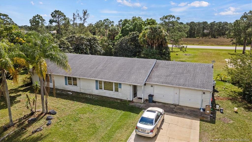 a aerial view of a house with swimming pool and a yard