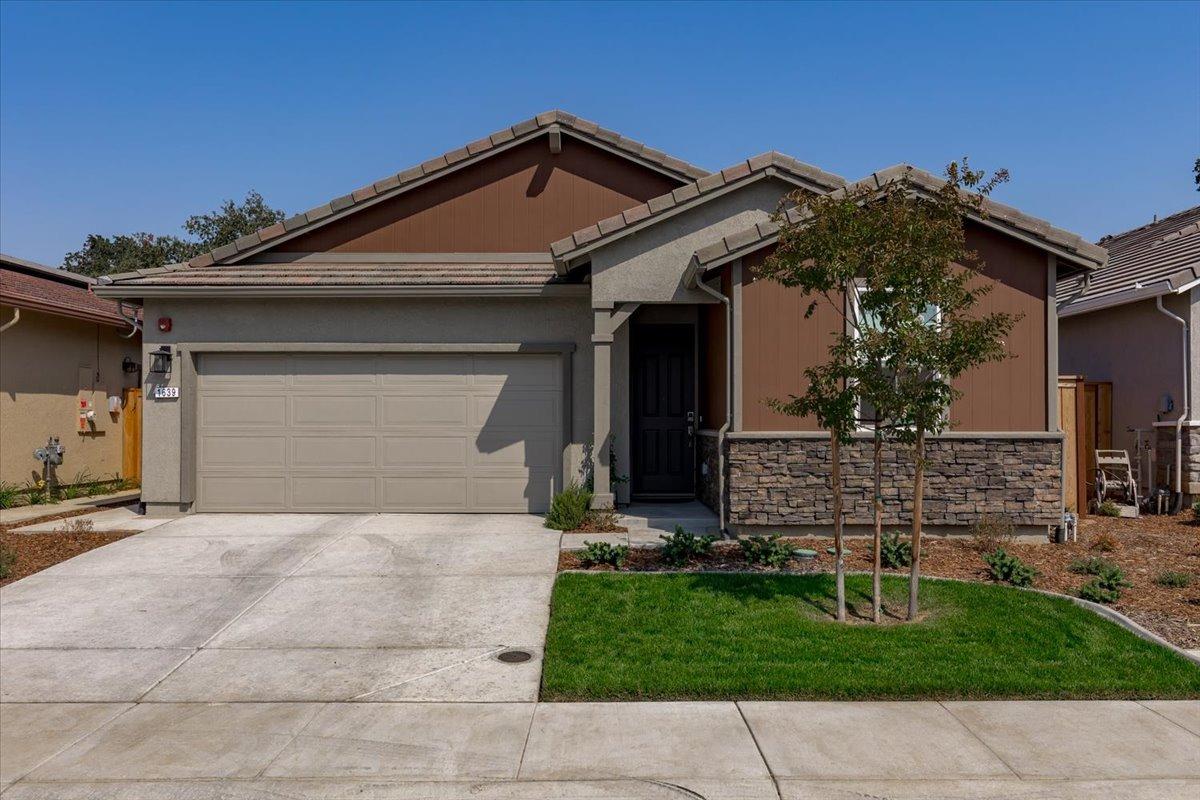 a front view of a house with a yard