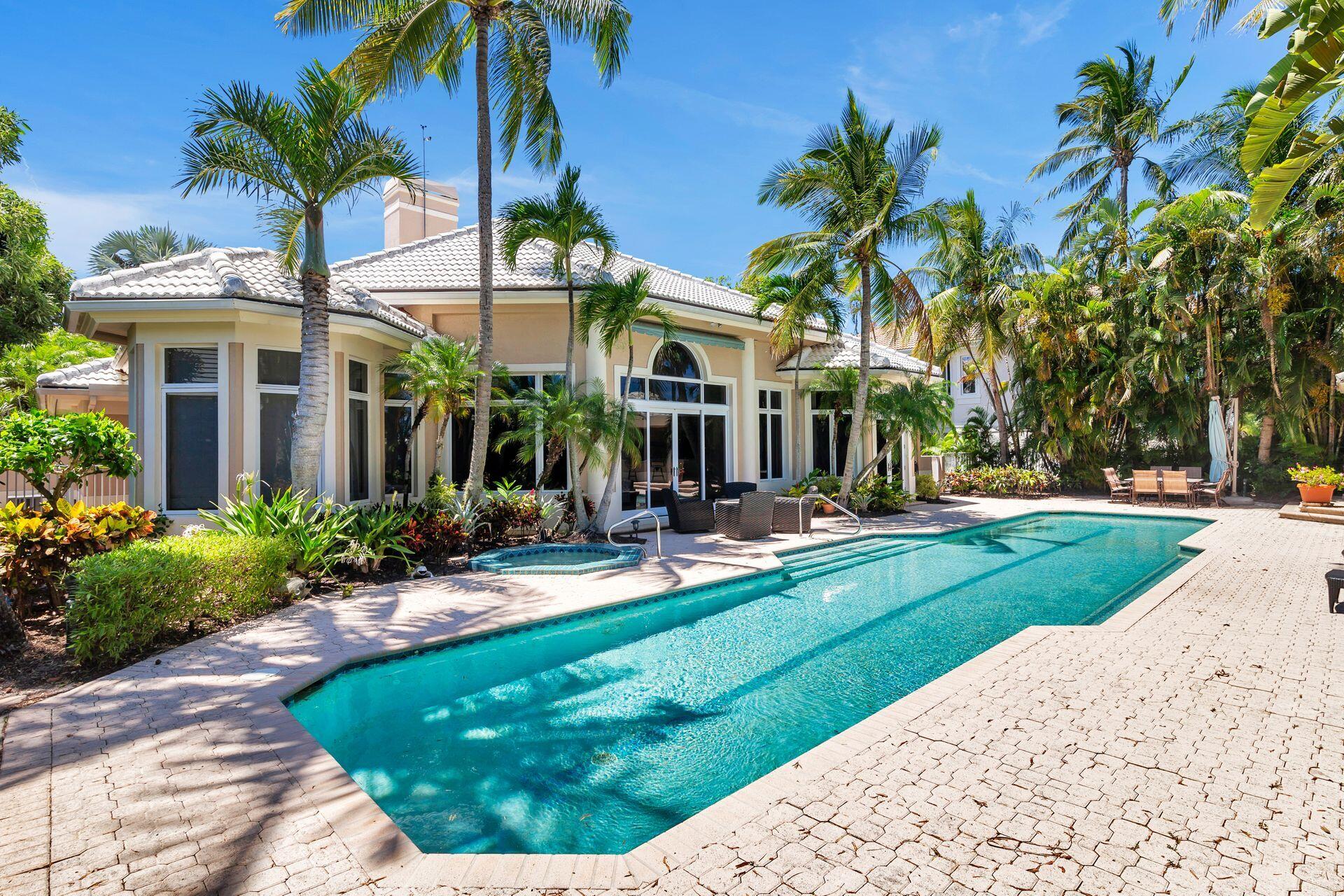 a view of a house with backyard sitting area and swimming pool