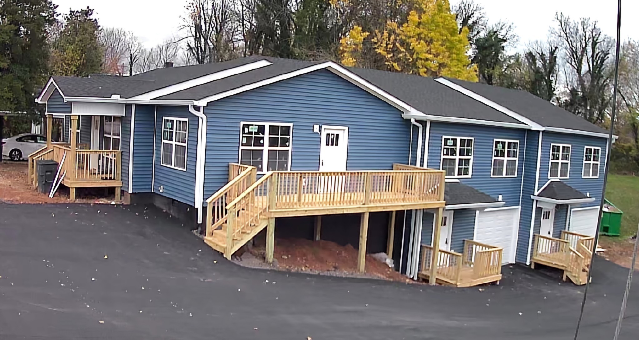 a view of house with a yard and sitting area