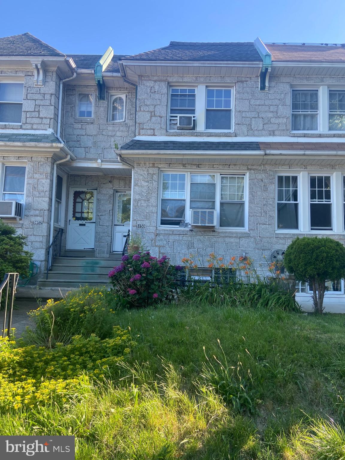 a view of a house with a garden and plants