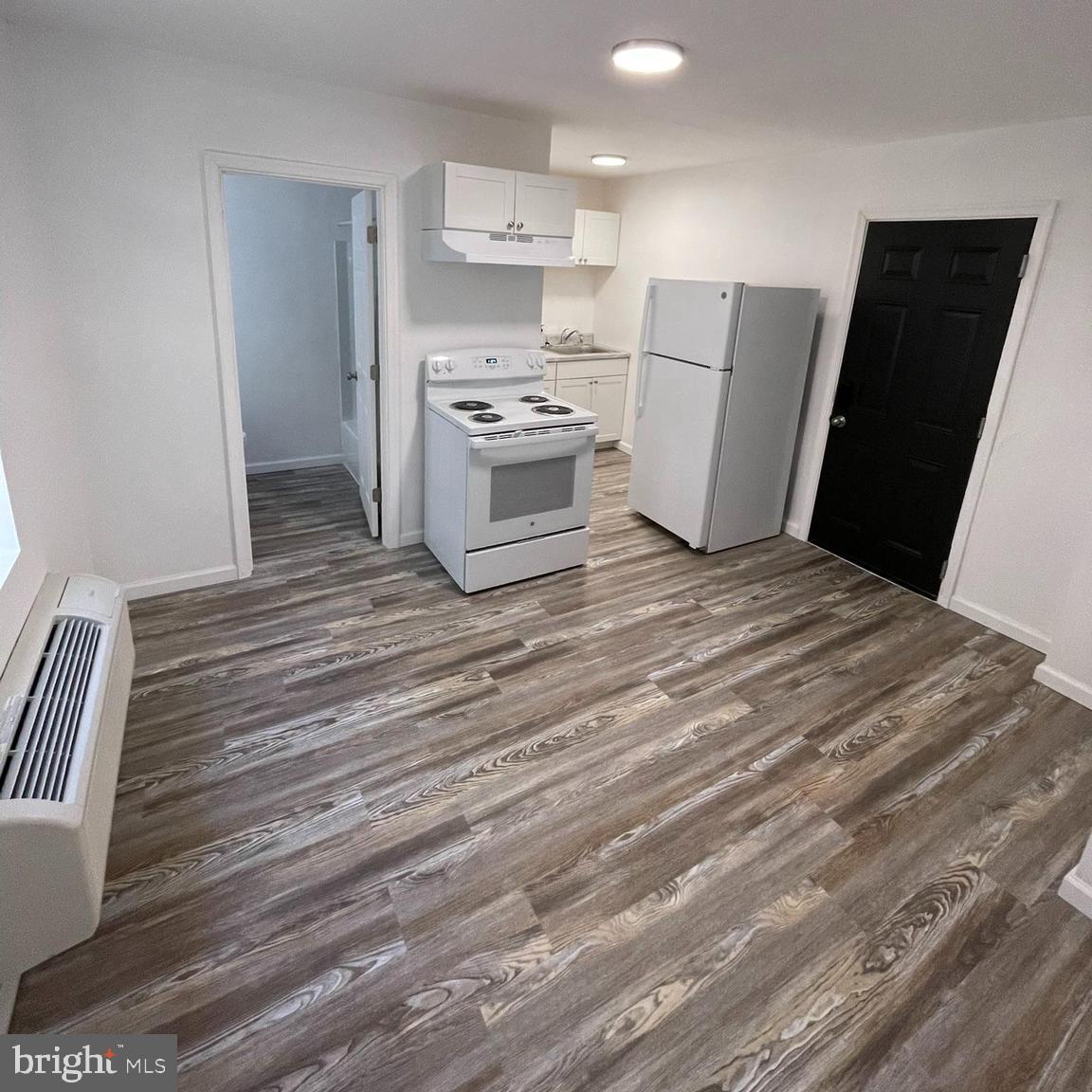 a kitchen with a refrigerator and a stove