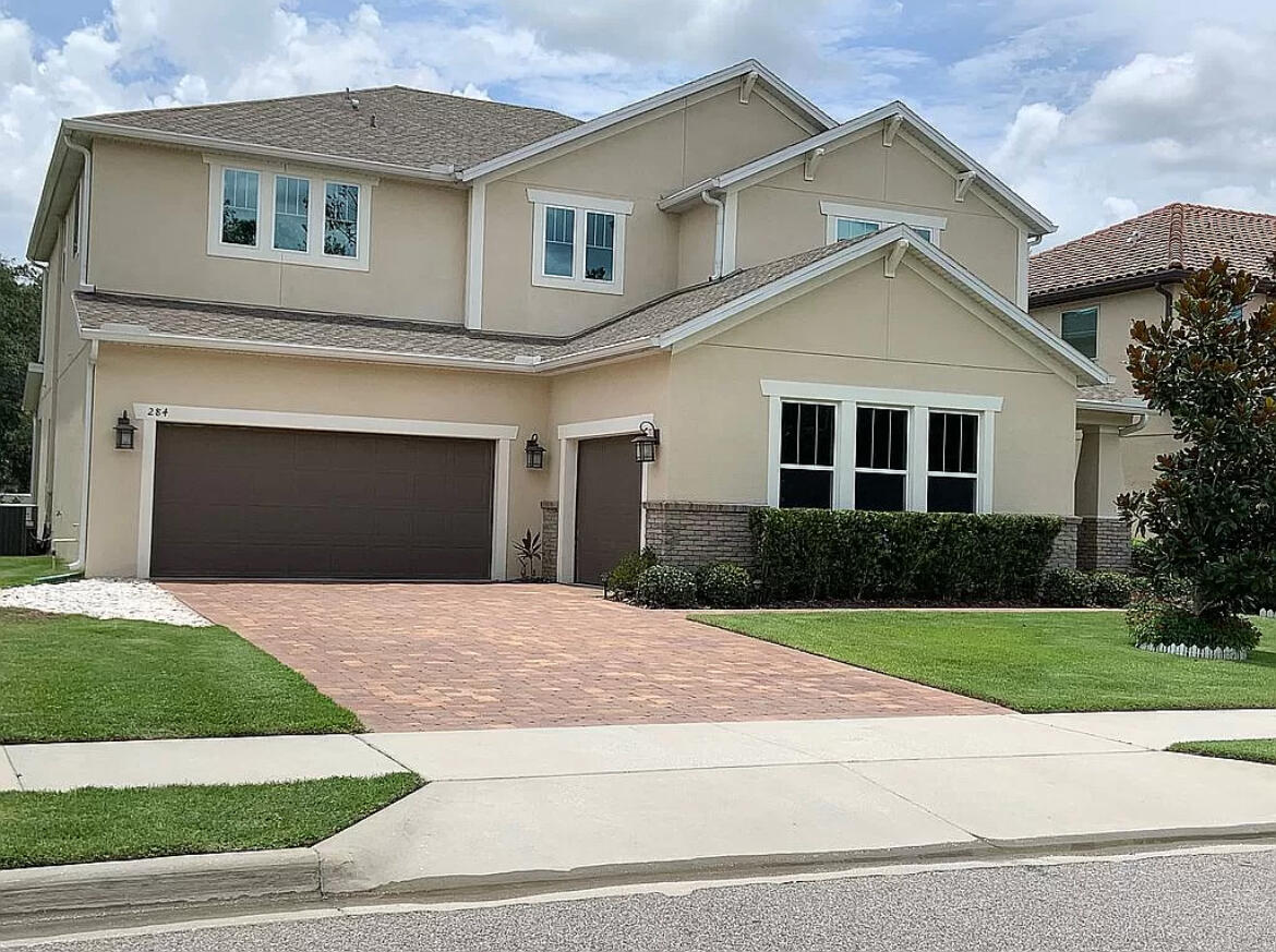 a front view of a house with a yard and garage