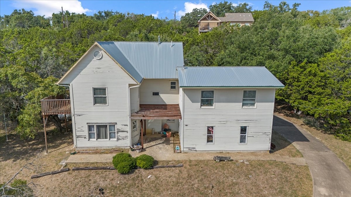 a aerial view of a house with a yard and potted plants