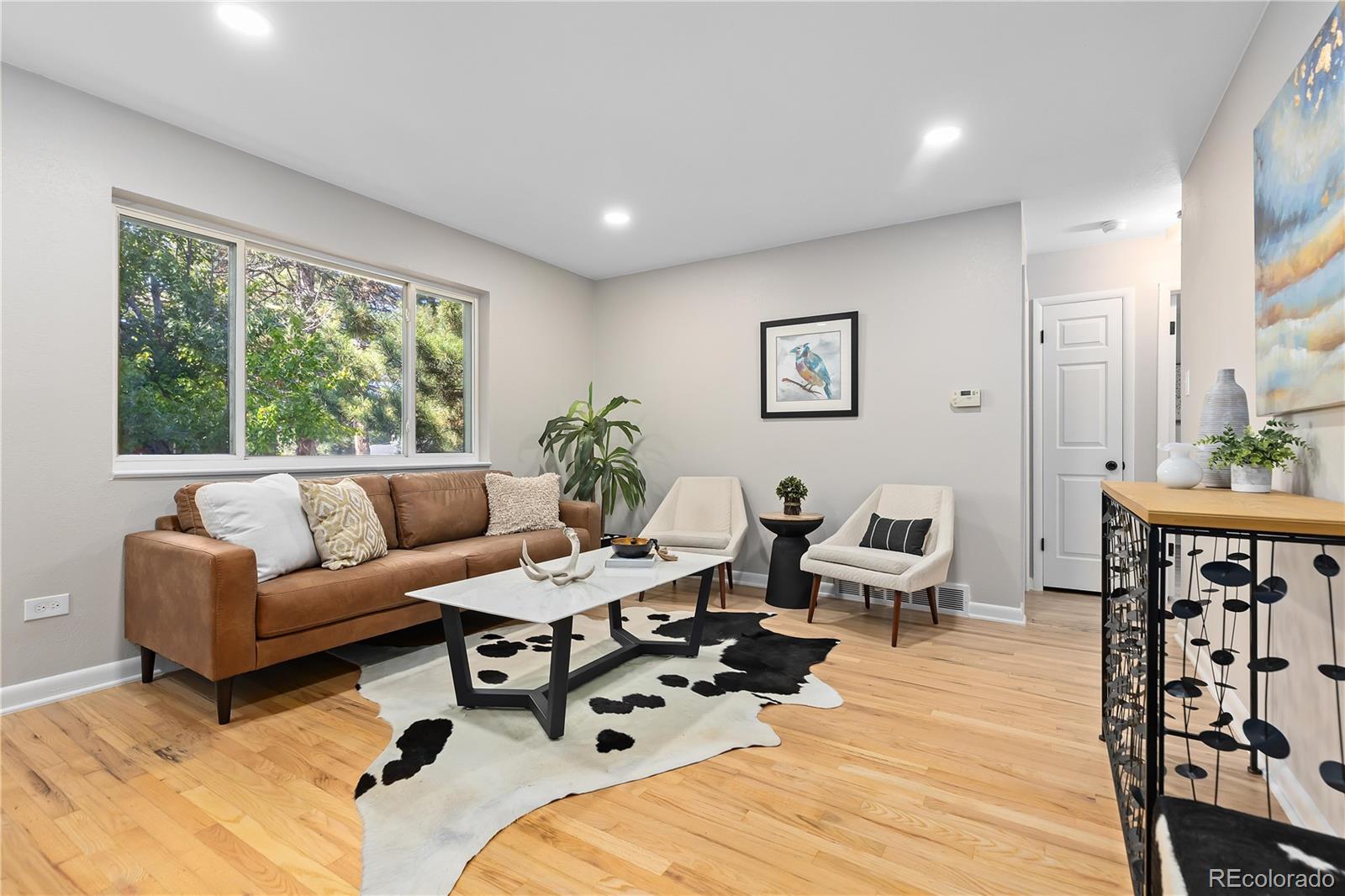 a living room with furniture a fireplace and a table