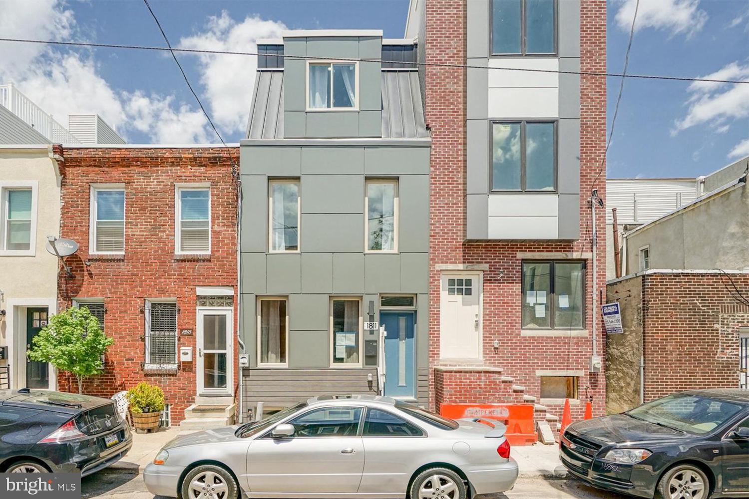 a front view of a house with car parked