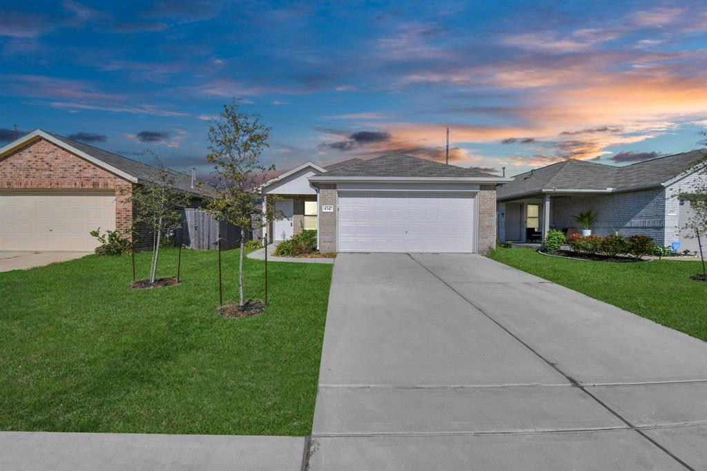 a front view of house with yard and green space