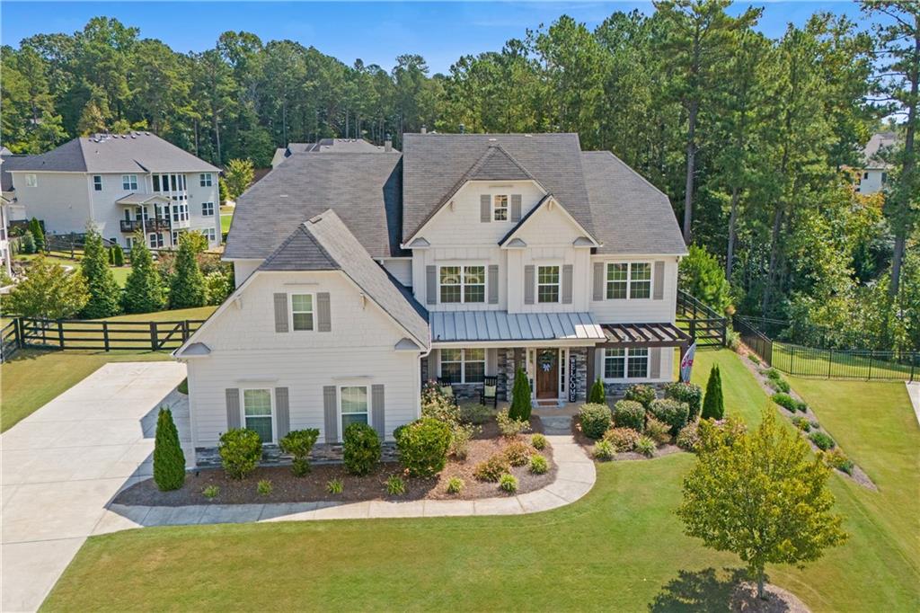 a aerial view of a house with a yard and potted plants