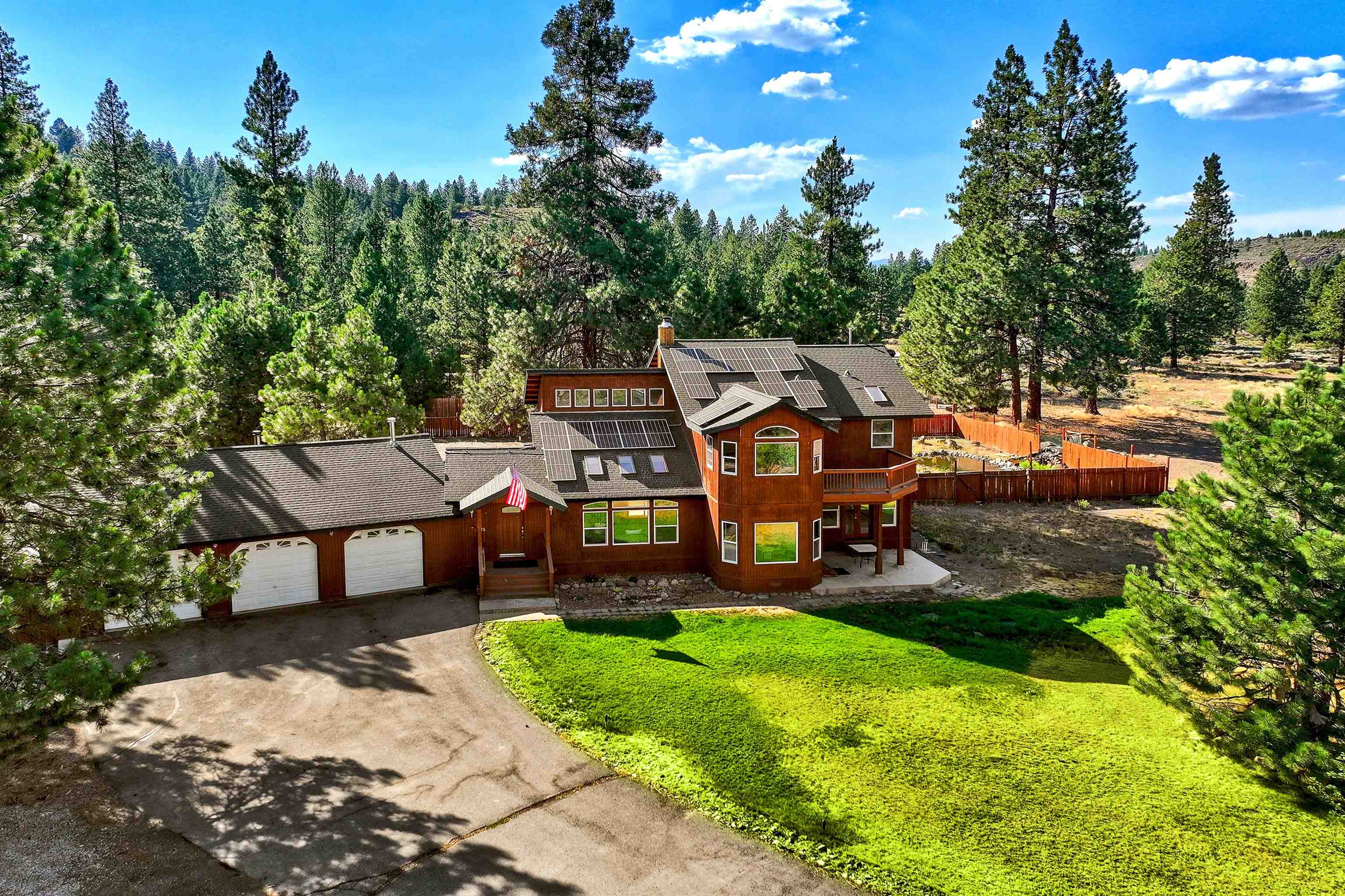 an aerial view of a house with swimming pool and big yard