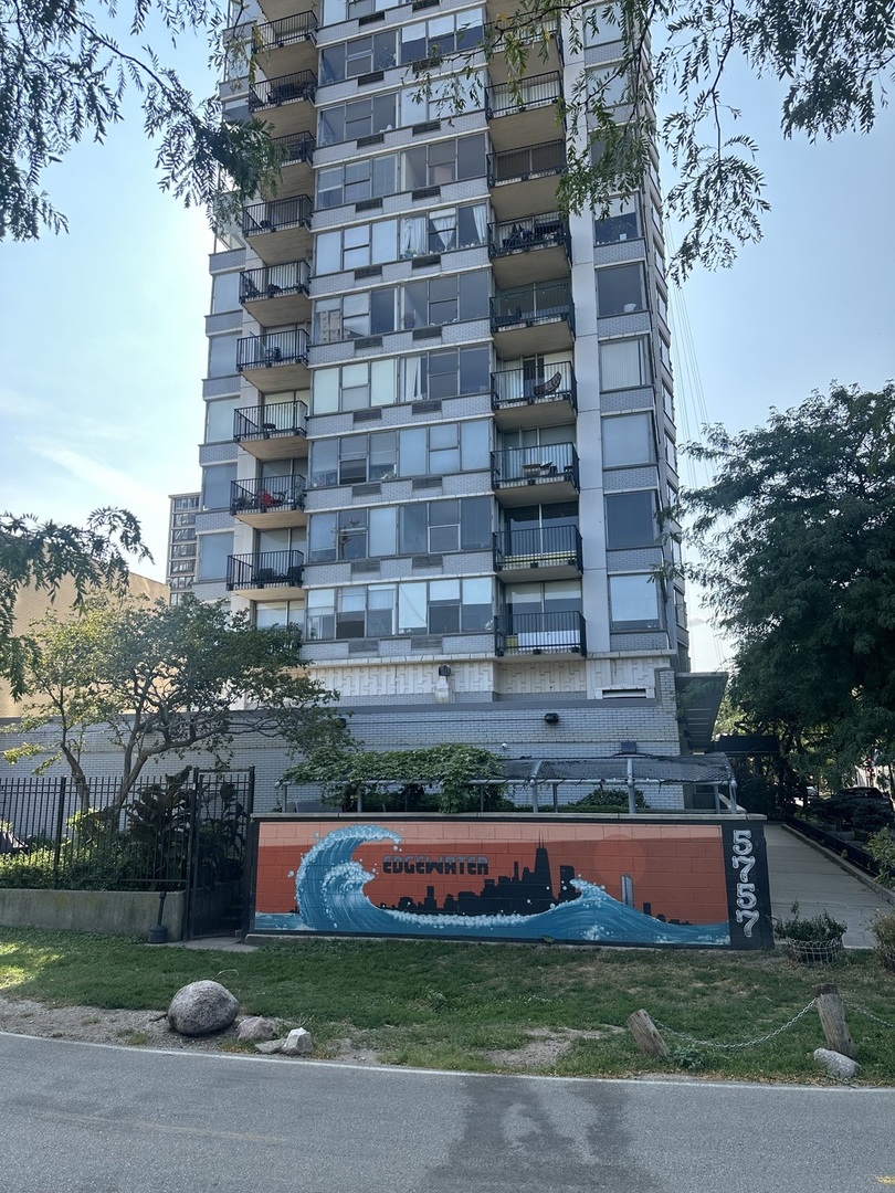 a view of a tall building next to a yard