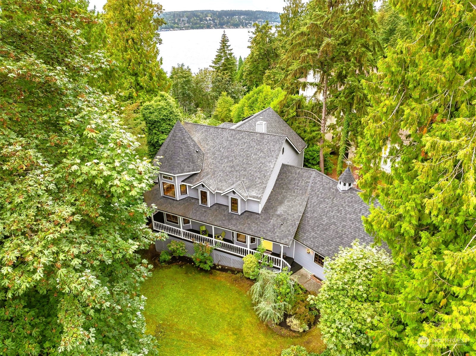 an aerial view of a house with swimming pool next to a yard