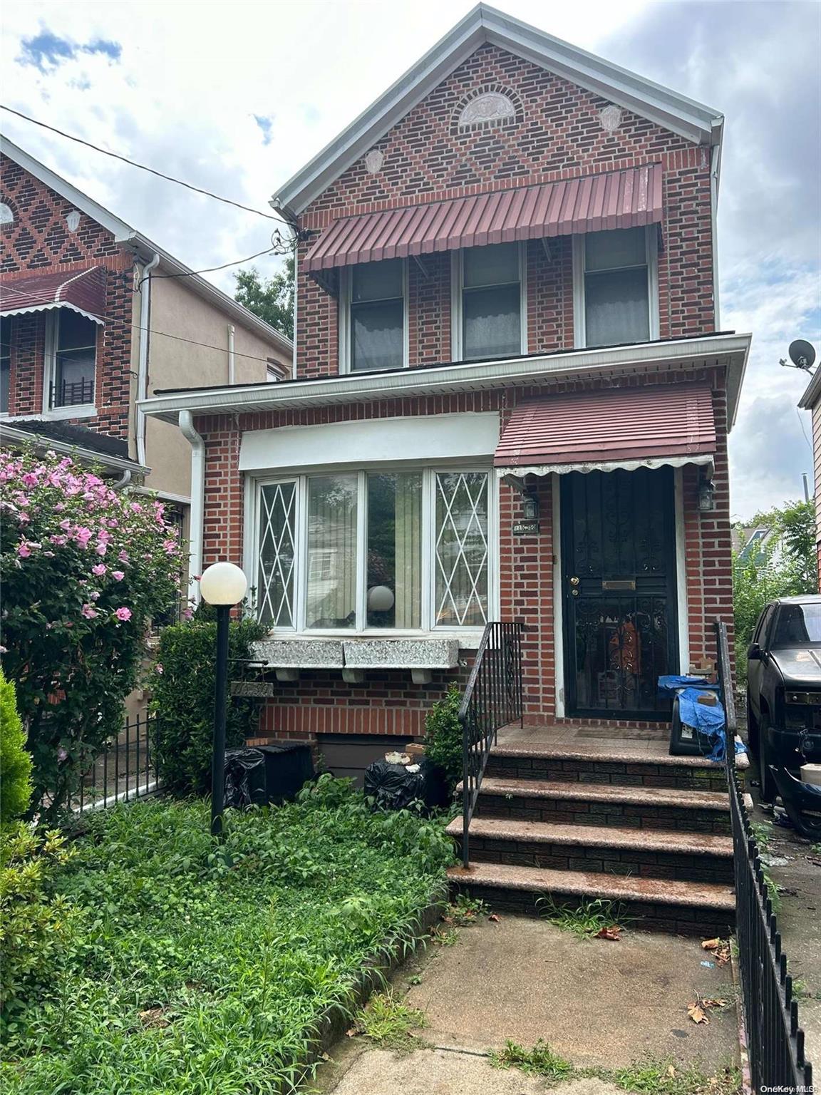 a front view of a house with a garden